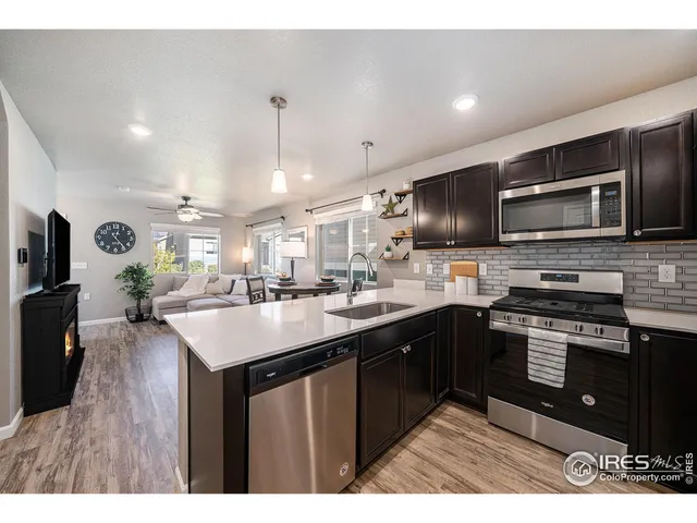 a kitchen with stainless steel appliances a sink stove and refrigerator