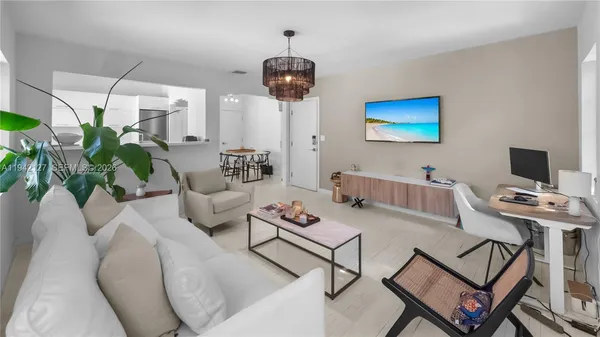 a living room with furniture a table and a potted plant