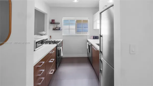 a kitchen with stainless steel appliances granite countertop a stove and a refrigerator