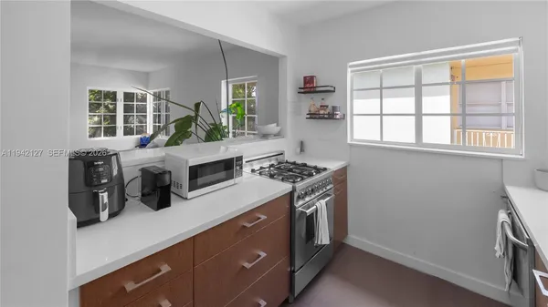 a kitchen with a stove and a white refrigerator