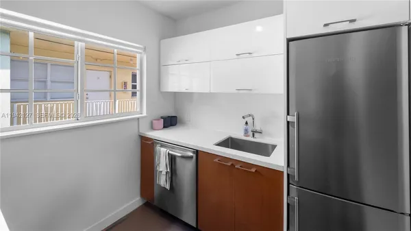 a kitchen with stainless steel appliances a refrigerator and a sink