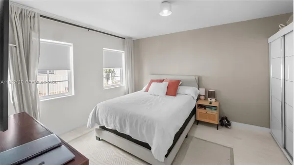 a bedroom with a bed and window