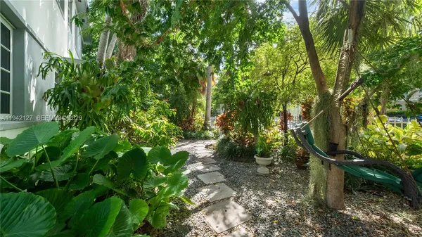 a backyard of a house with lots of green space and sink