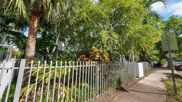 a view of a park with plants and large trees