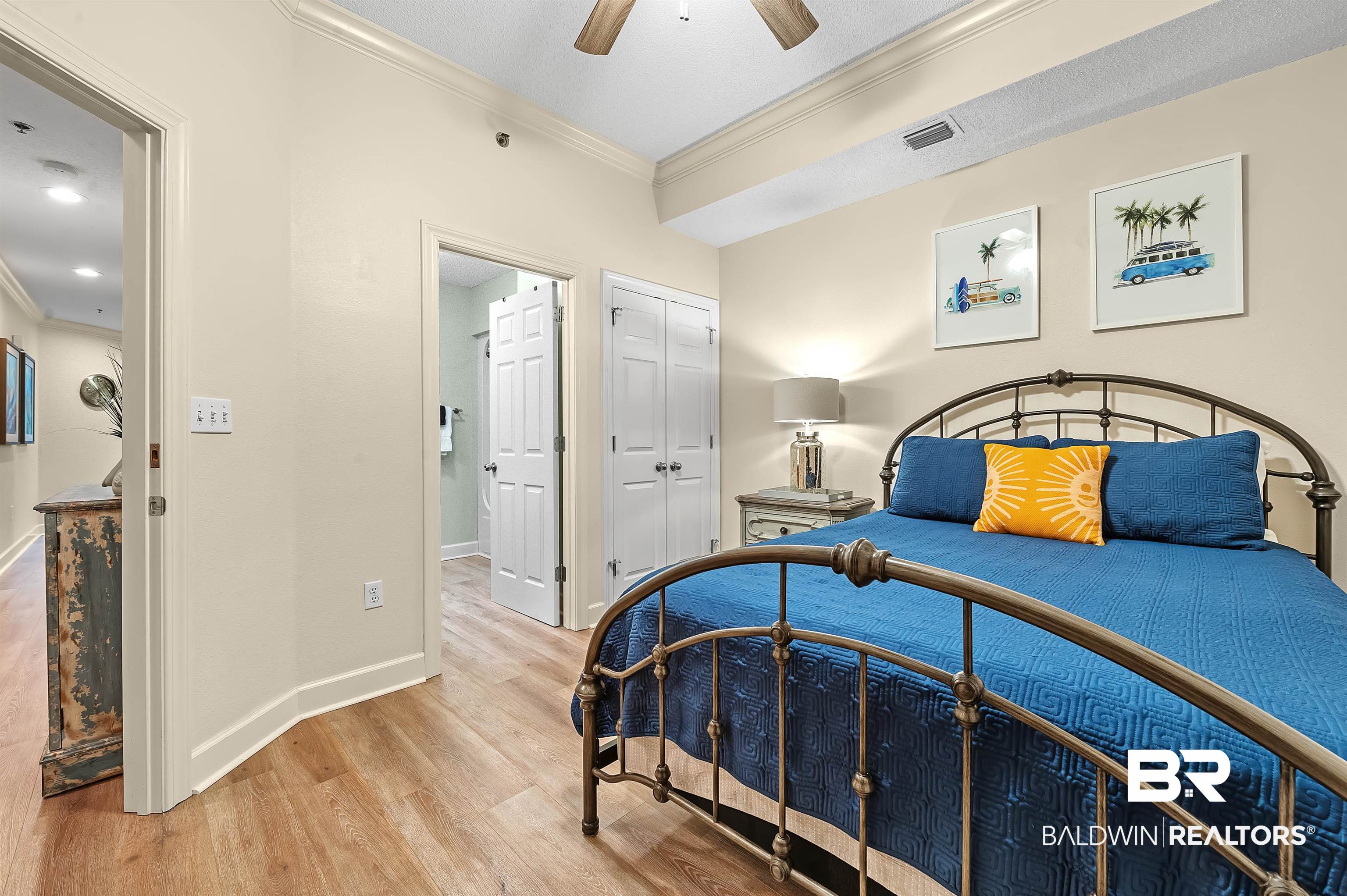 27582 Canal Road, Unit 2104 Orange Beach, AL 36561 - Photo 27 of 35 Bedroom featuring ceiling fan, a closet, crown molding, and light hardwood / wood-style floors