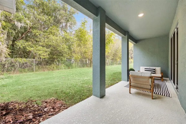 a outdoor view of a house with a lounge chair