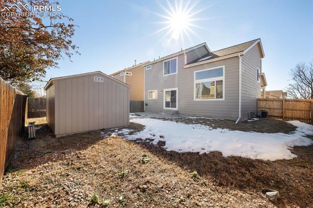 7655 Coffee Road Peyton, CO 80831 - Photo 25 of 31 Back of property featuring a shed