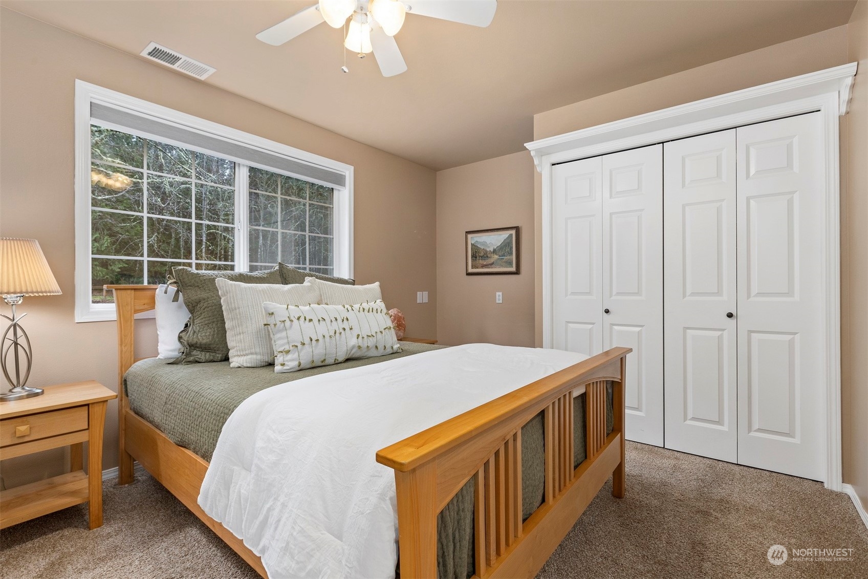 3313 Y Road Bellingham, WA 98226 - Photo 17 of 40 a bedroom with a bed a chandelier and a window