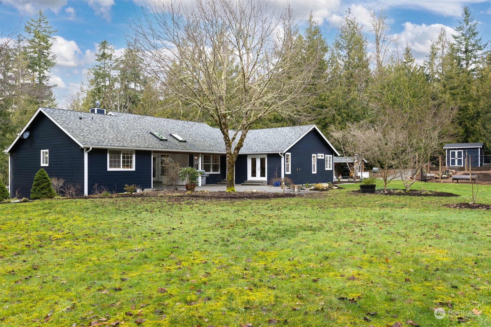 3313 Y Road Bellingham, WA 98226 - Photo 25 of 40 a front view of a house with a garden and trees