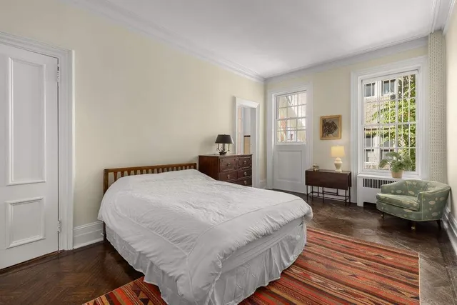 a spacious bedroom with a balcony a bed and a fireplace