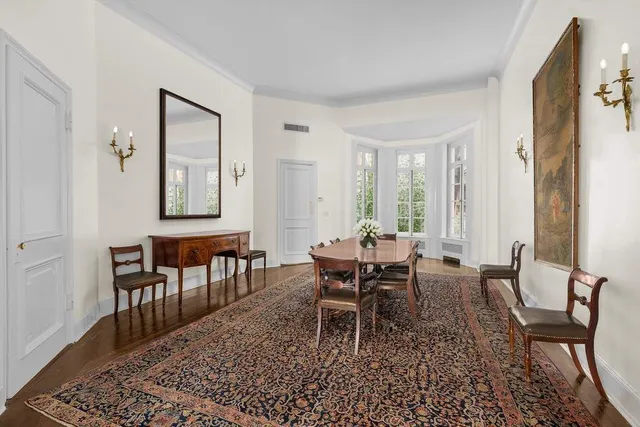 a view of an entryway with wooden floor and a livingroom view