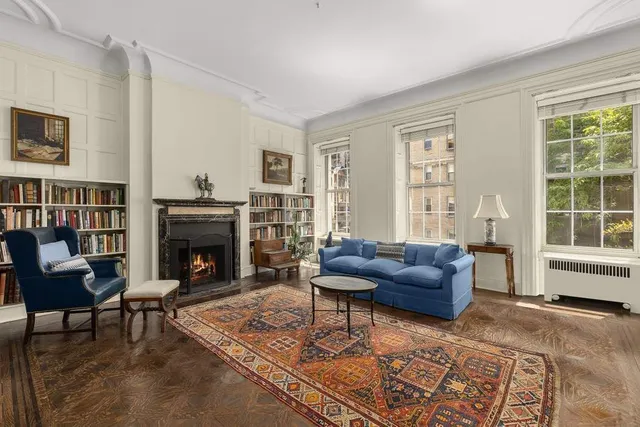 a dining room with furniture window and wooden floor