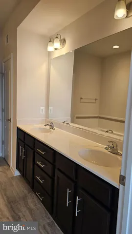 a bathroom with a sink vanity and a mirror