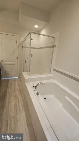 a bathroom with a bathtub and a shower