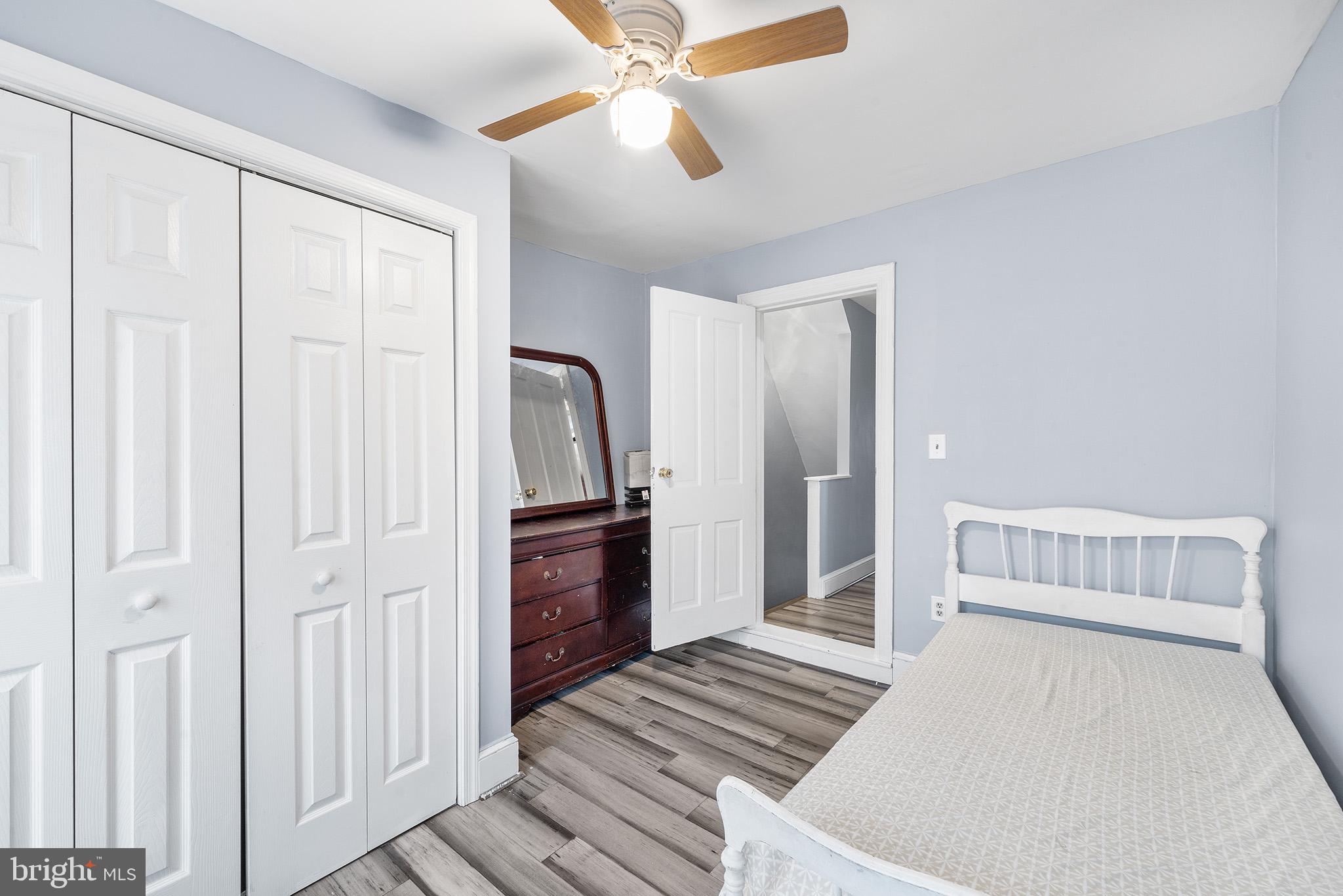 329 South Hanover Street Pottstown, PA 19465 - Photo 12 of 23 a bedroom with a bed and a chandelier