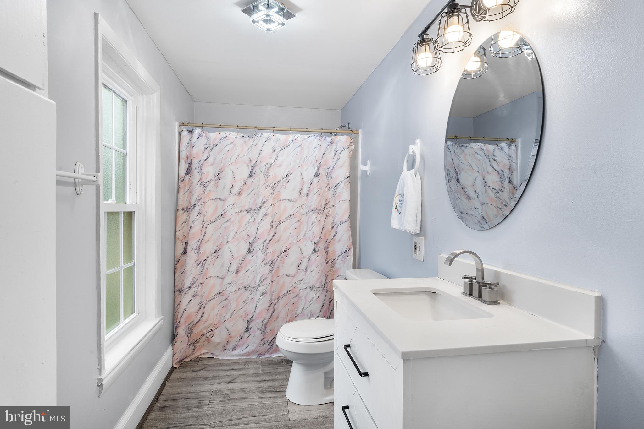 329 South Hanover Street Pottstown, PA 19465 - Photo 15 of 23 a bathroom with a sink a toilet and a mirror
