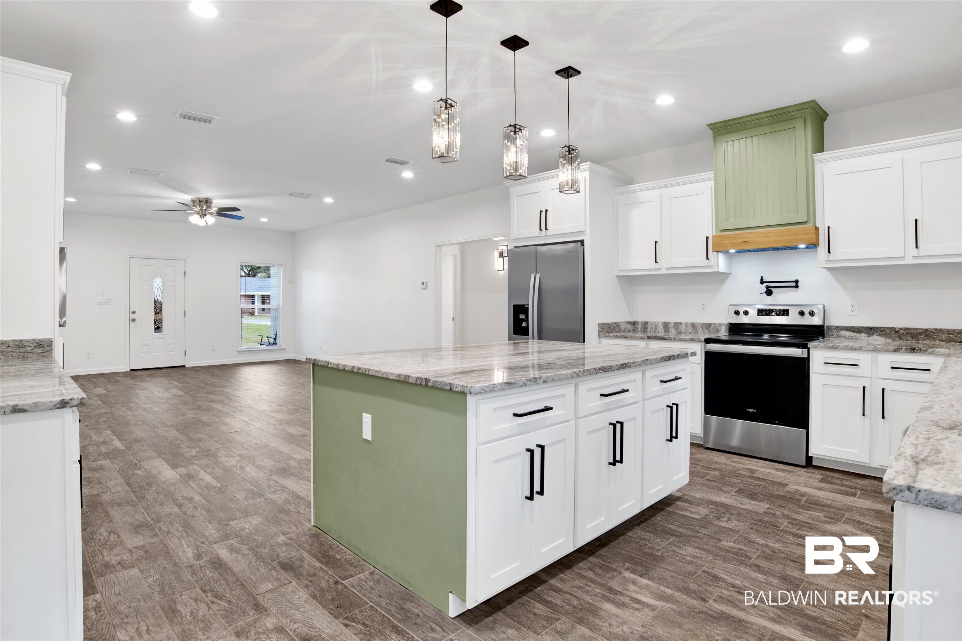 10871 Somerset Road Grand Bay, AL 36541 - Photo 3 of 31 Kitchen with a center island, stainless steel appliances, and white cabinets