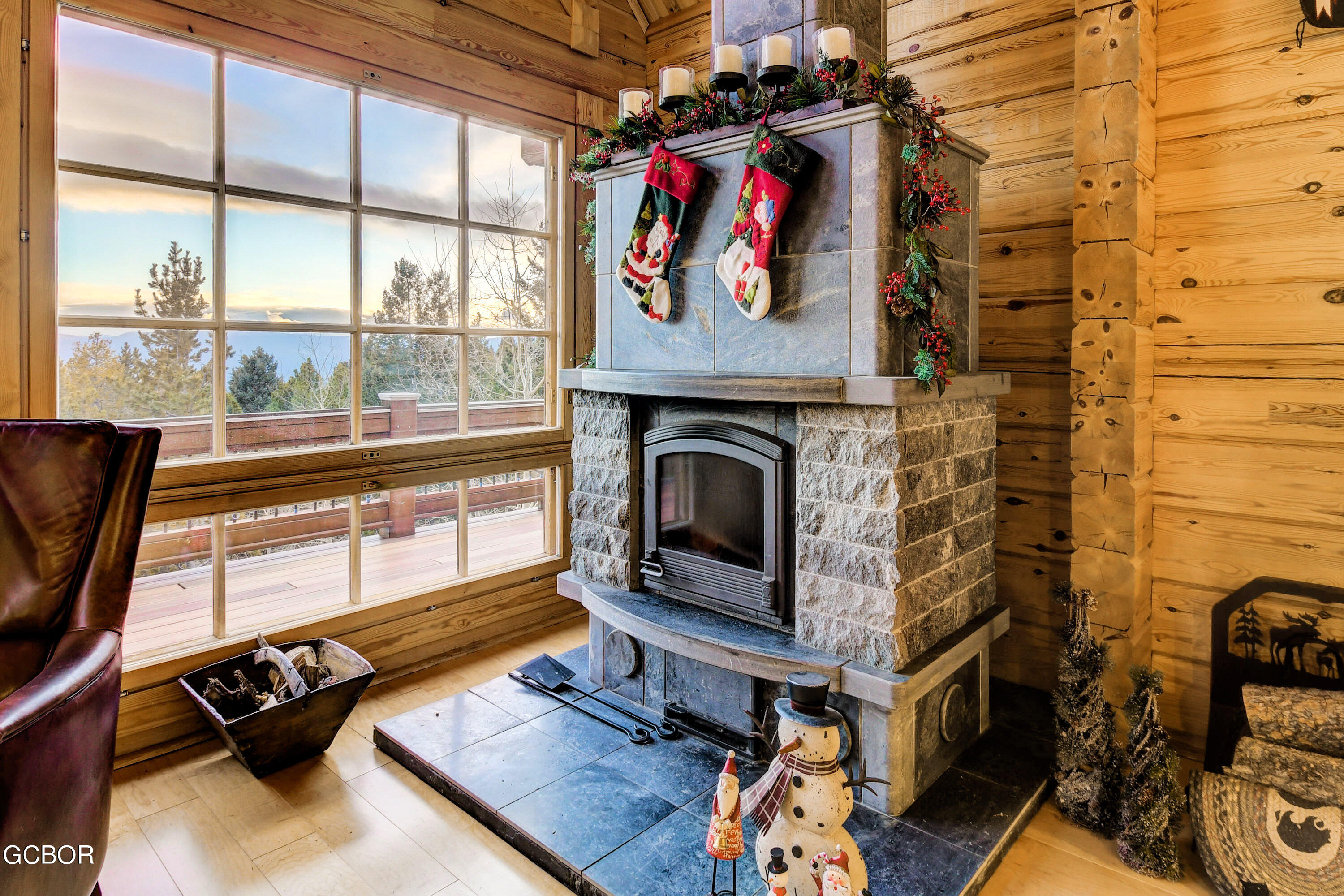 11006 Timothys Drive Conifer, CO 80433 - Photo 14 of 45 a living room with furniture a fireplace and a floor to ceiling window