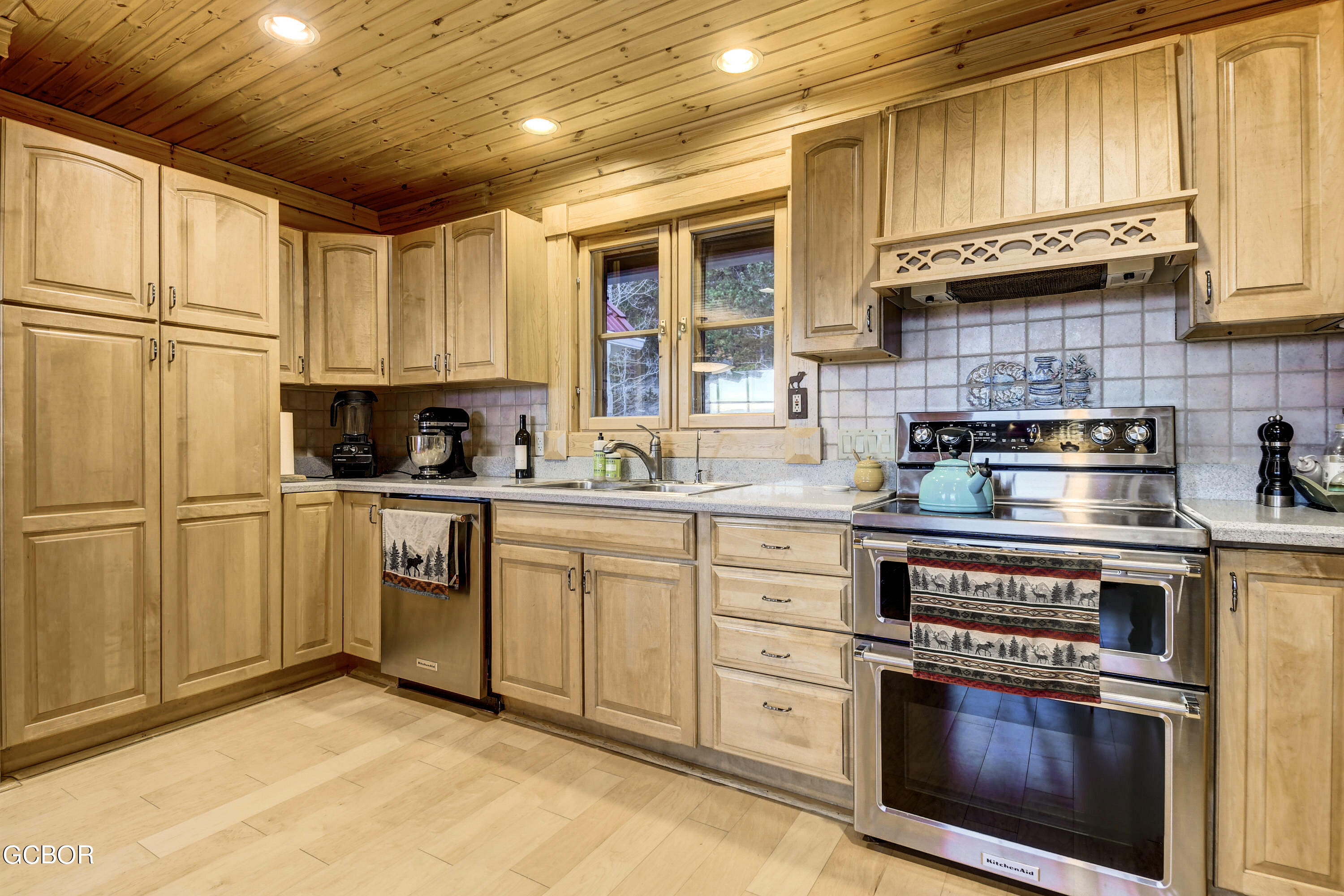 11006 Timothys Drive Conifer, CO 80433 - Photo 16 of 45 a kitchen with cabinets stainless steel appliances and a window