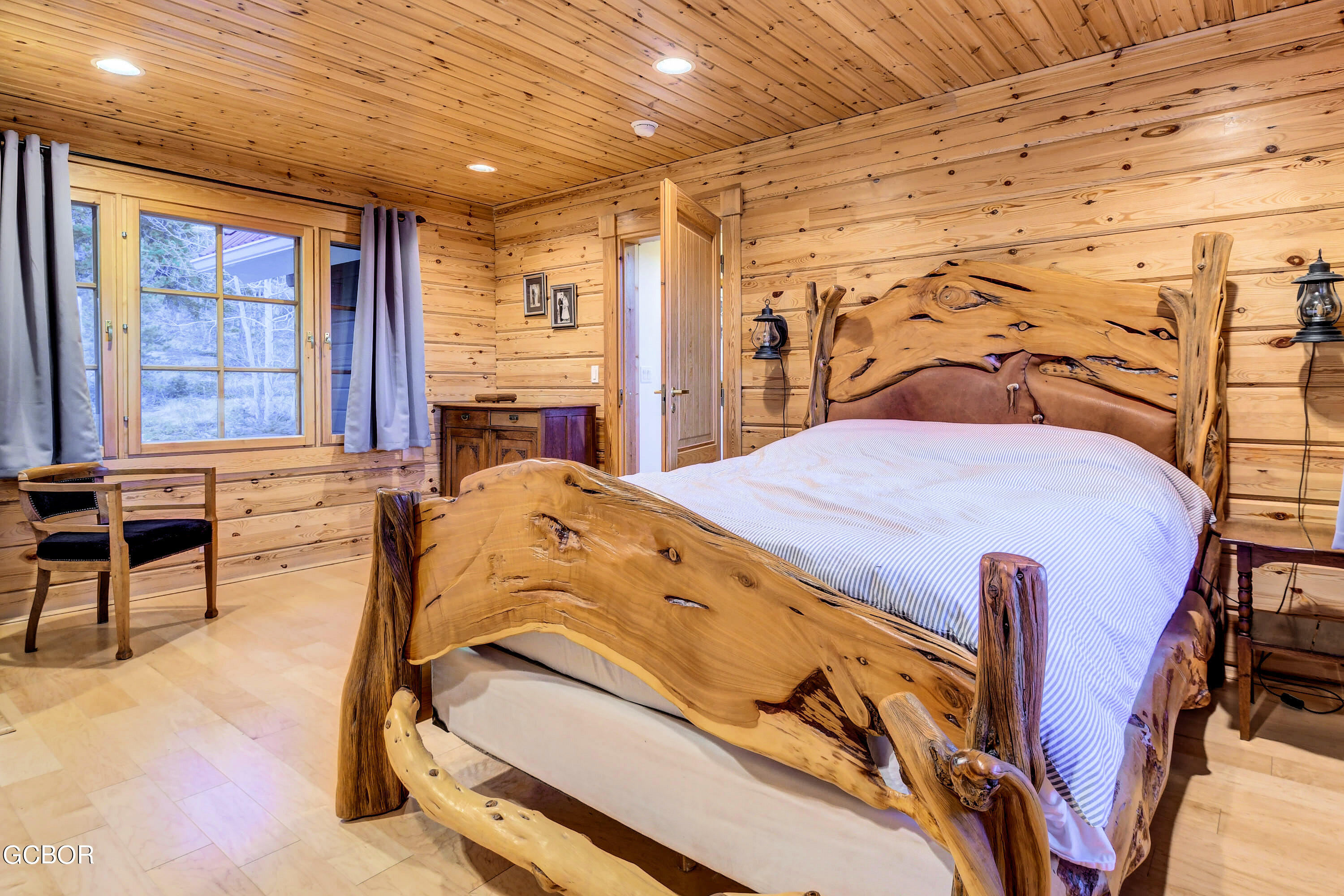 11006 Timothys Drive Conifer, CO 80433 - Photo 19 of 45 a bed sitting in a room next to a window