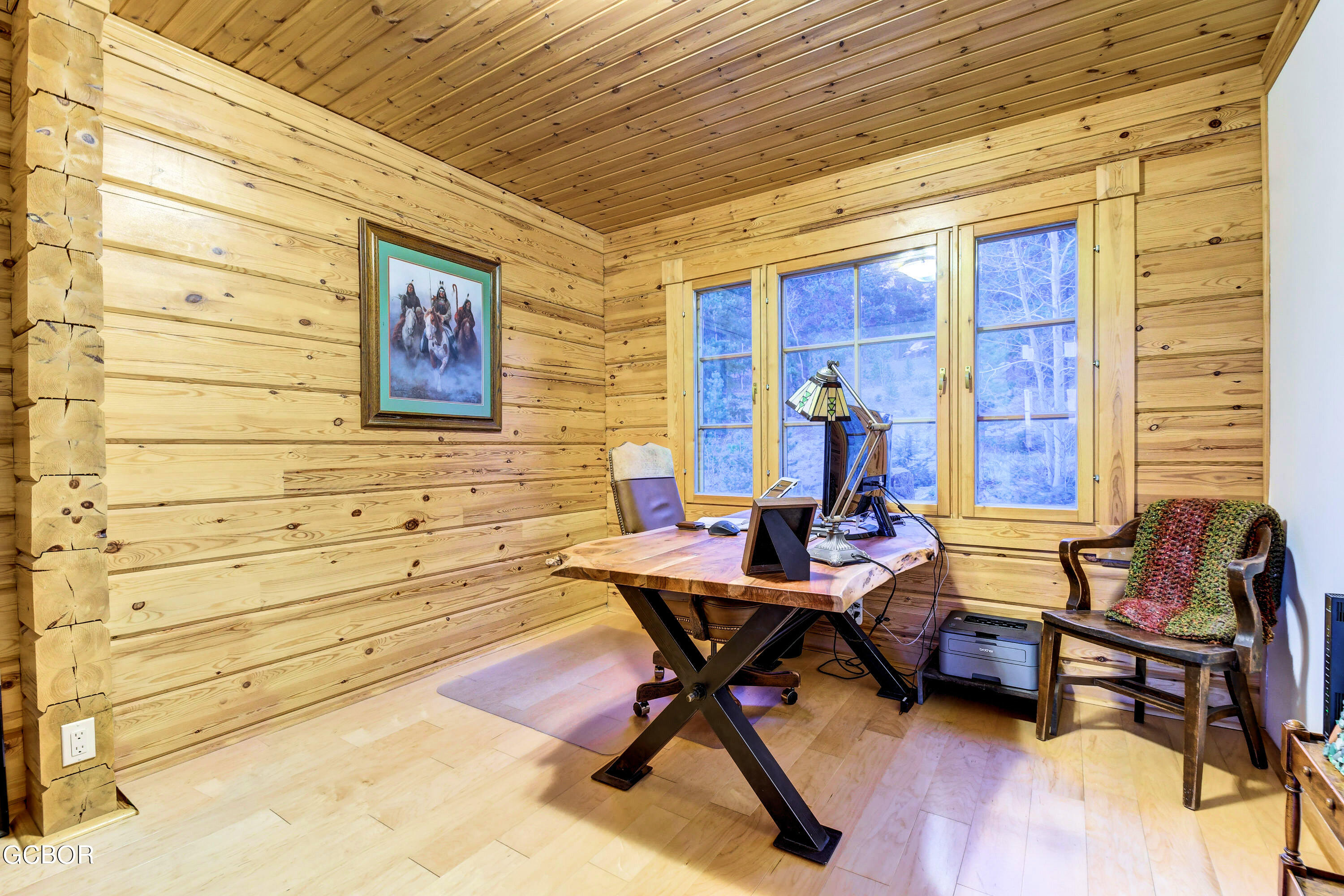 11006 Timothys Drive Conifer, CO 80433 - Photo 21 of 45 a work room with furniture and wooden floor