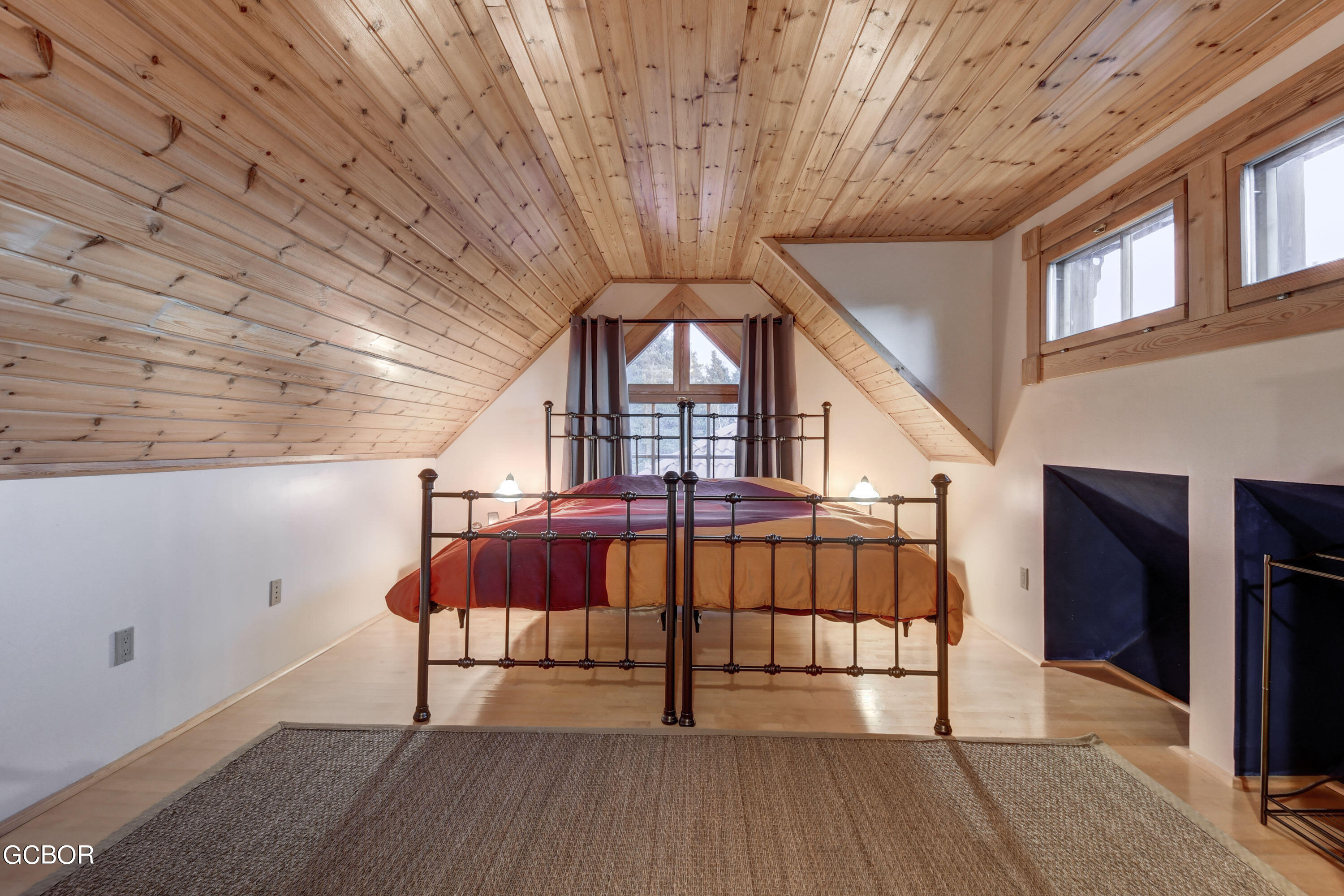 11006 Timothys Drive Conifer, CO 80433 - Photo 24 of 45 a view of staircase with a large window and wooden floor