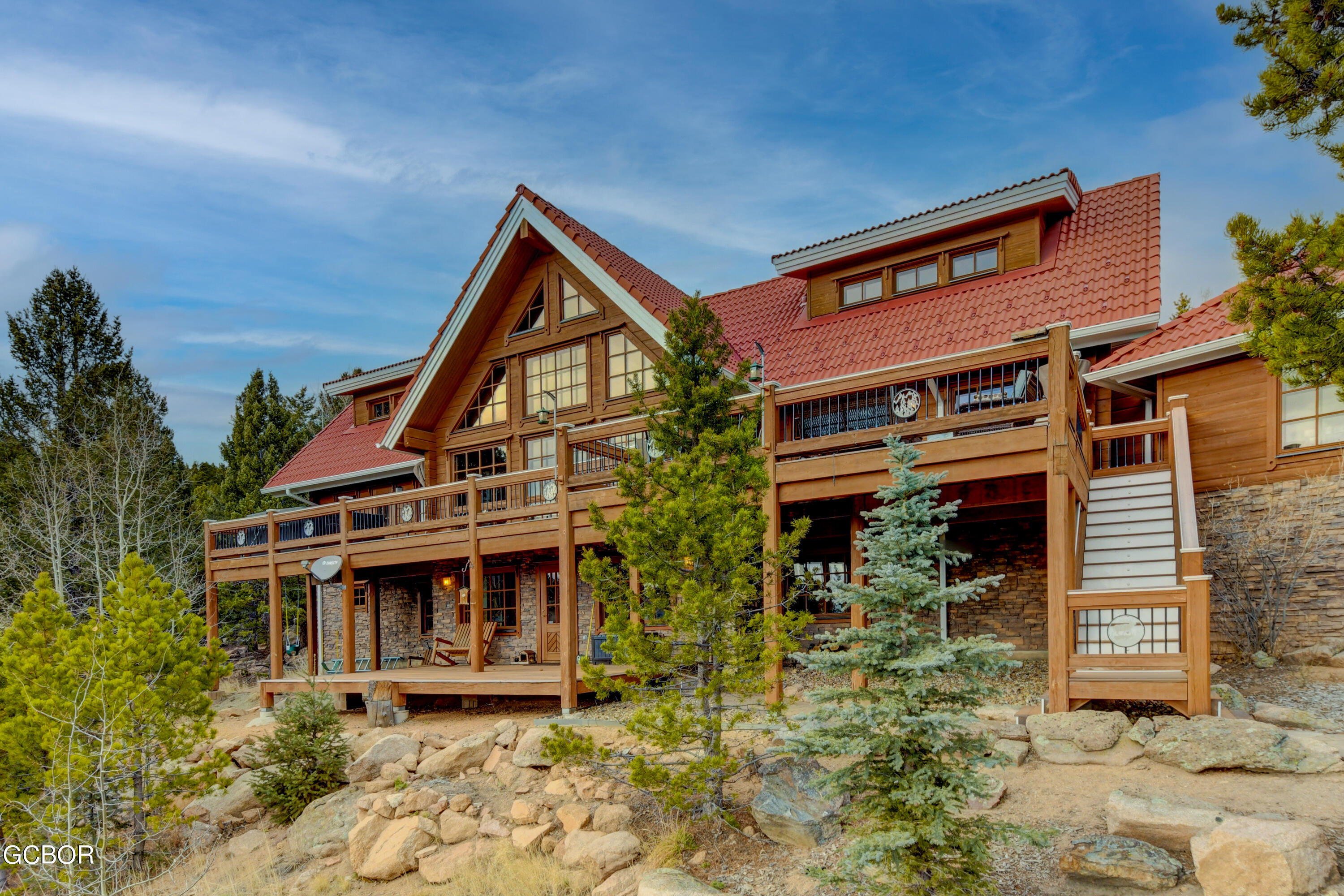 11006 Timothys Drive Conifer, CO 80433 - Photo 30 of 45 front view of a house with a yard