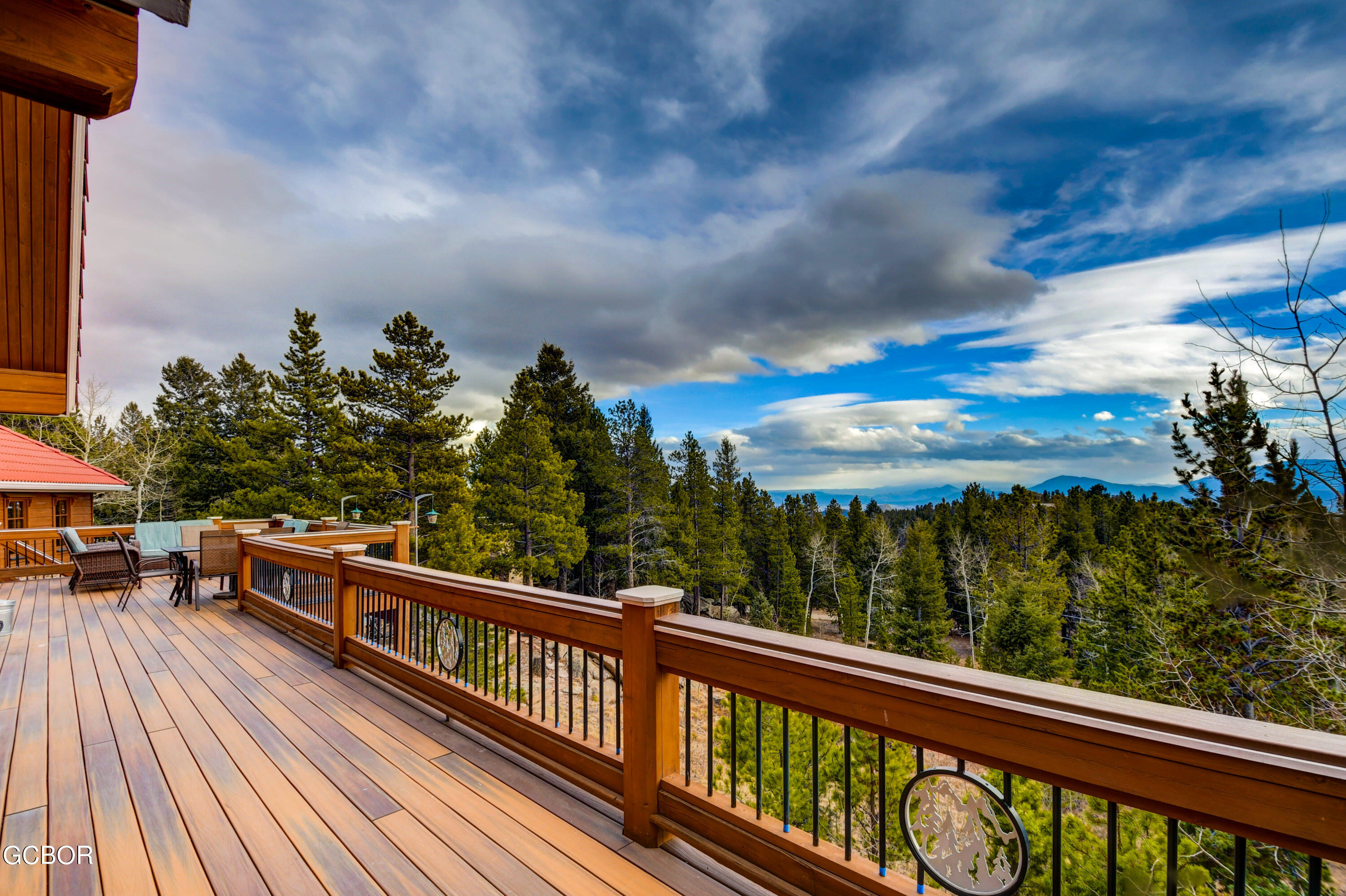 11006 Timothys Drive Conifer, CO 80433 - Photo 33 of 45 a view of a balcony with wooden chairs