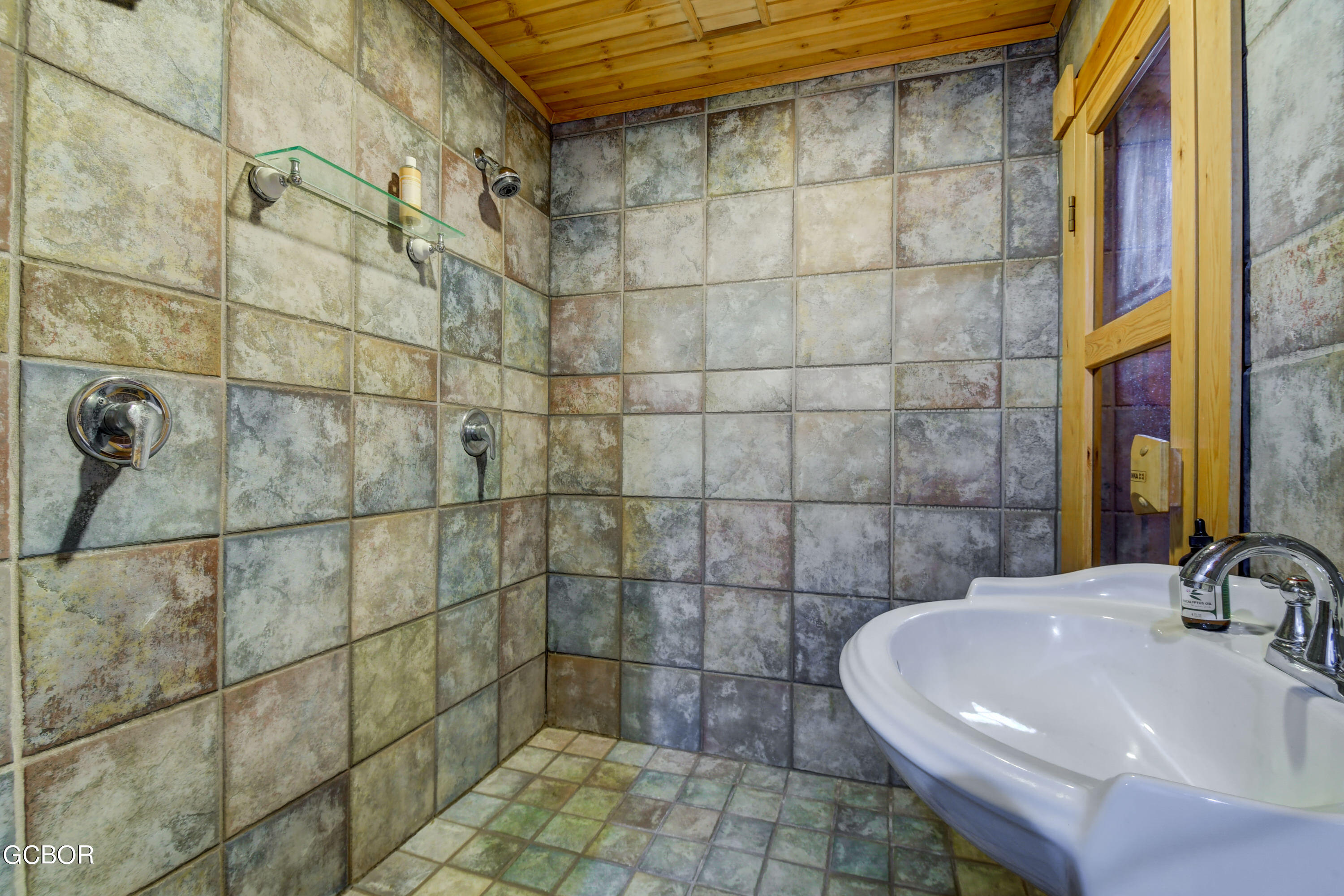 11006 Timothys Drive Conifer, CO 80433 - Photo 37 of 45 a bathroom with a sink and a shower
