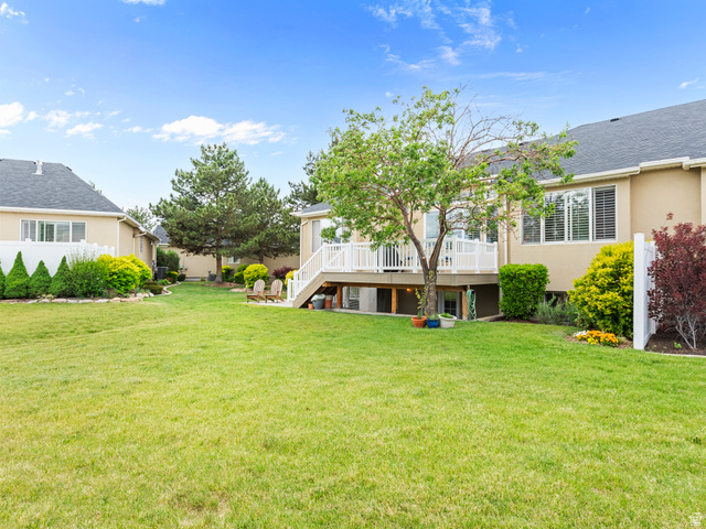 11881 Cottage View Lane Draper, UT 84020 - Photo 20 of 29 Spacious backyard featuring a multi-level deck with white railing, mature trees, and a manicured lawn