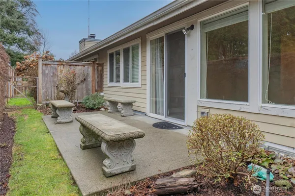 a view of a house with backyard and sitting area