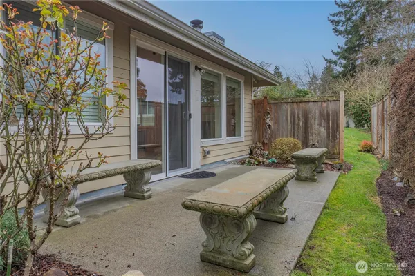 a view of a patio with table and chairs with a fire pit