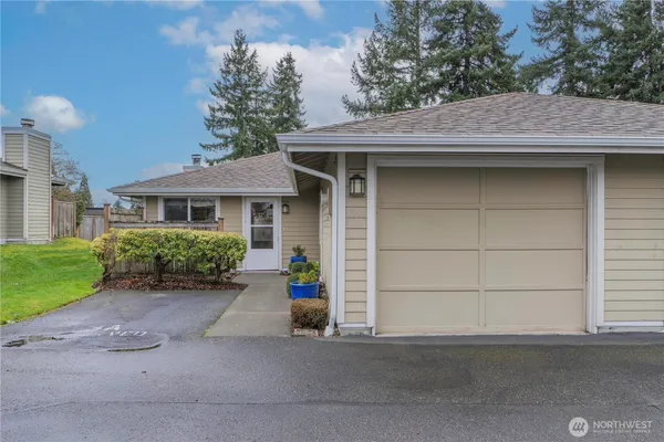 a view of a house with a yard and garage