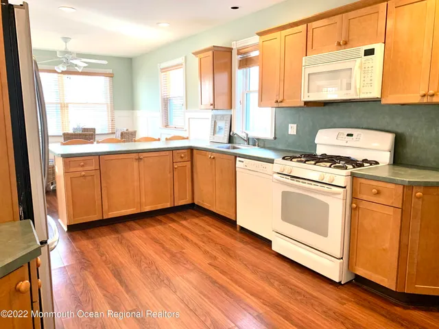 a bathroom with a sink a toilet and a shower