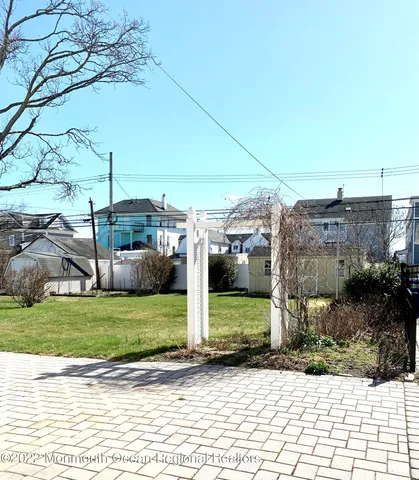 a view of a patio with table and chairs with wooden floor and fence