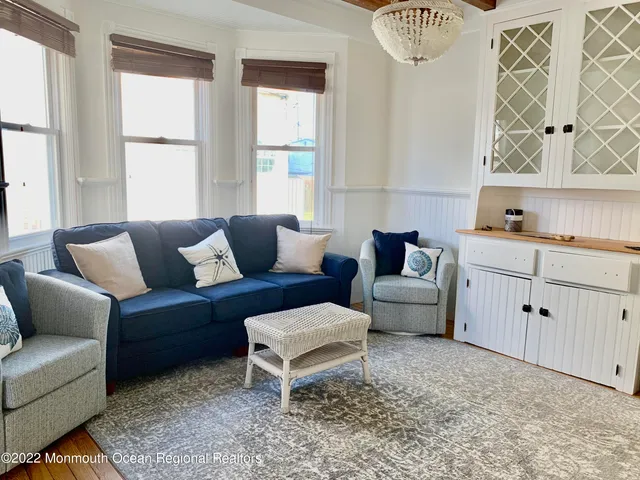 a kitchen with stainless steel appliances granite countertop a stove top oven a sink dishwasher and a dining table with wooden floor