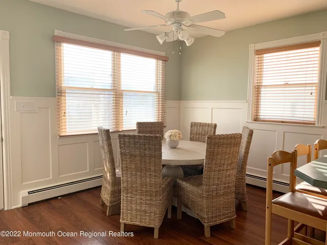 a kitchen with stainless steel appliances granite countertop a stove a sink and white cabinets with wooden floor