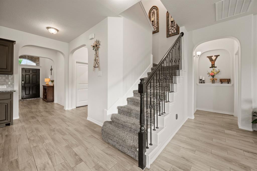 15817 White Mill Road Fort Worth, TX 76177 - Photo 18 of 27 a view of a hallway with wooden floor and staircase