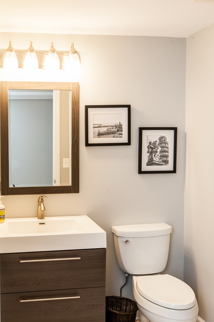1 Juniper Road Rolling Meadows, IL 60008 - Photo 29 of 29 a bathroom with a toilet a sink and mirror