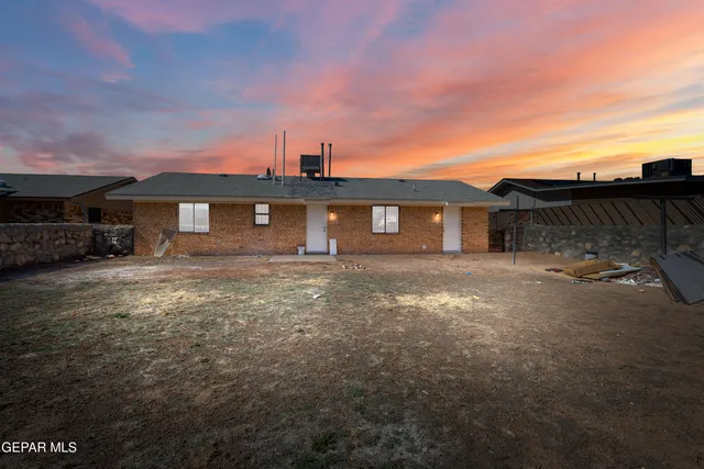 a view of a white house with a yard