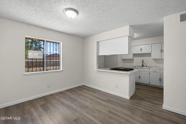 a kitchen with stainless steel appliances granite countertop a sink stove a refrigerator and cabinets