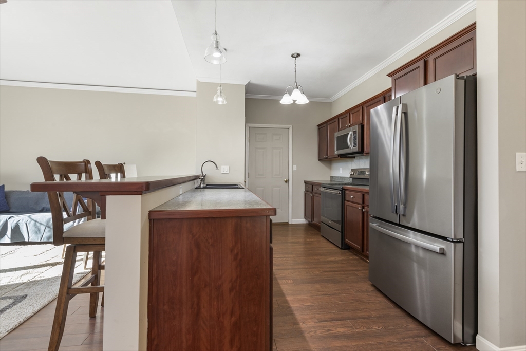 204 Brookfield Road Charlton, MA 01507 - Photo 13 of 36 a kitchen with kitchen island a counter top space a sink stainless steel appliances and cabinets