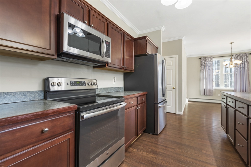204 Brookfield Road Charlton, MA 01507 - Photo 14 of 36 a kitchen with stainless steel appliances granite countertop a stove and a microwave