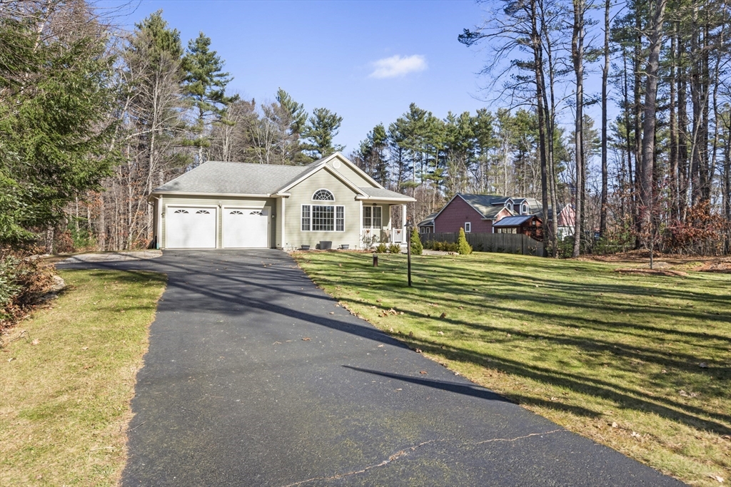 204 Brookfield Road Charlton, MA 01507 - Photo 2 of 36 a view of a house with a big yard and large trees