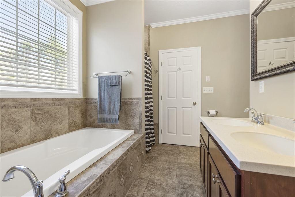 204 Brookfield Road Charlton, MA 01507 - Photo 21 of 36 a bathroom with a granite countertop sink a mirror and a bathtub