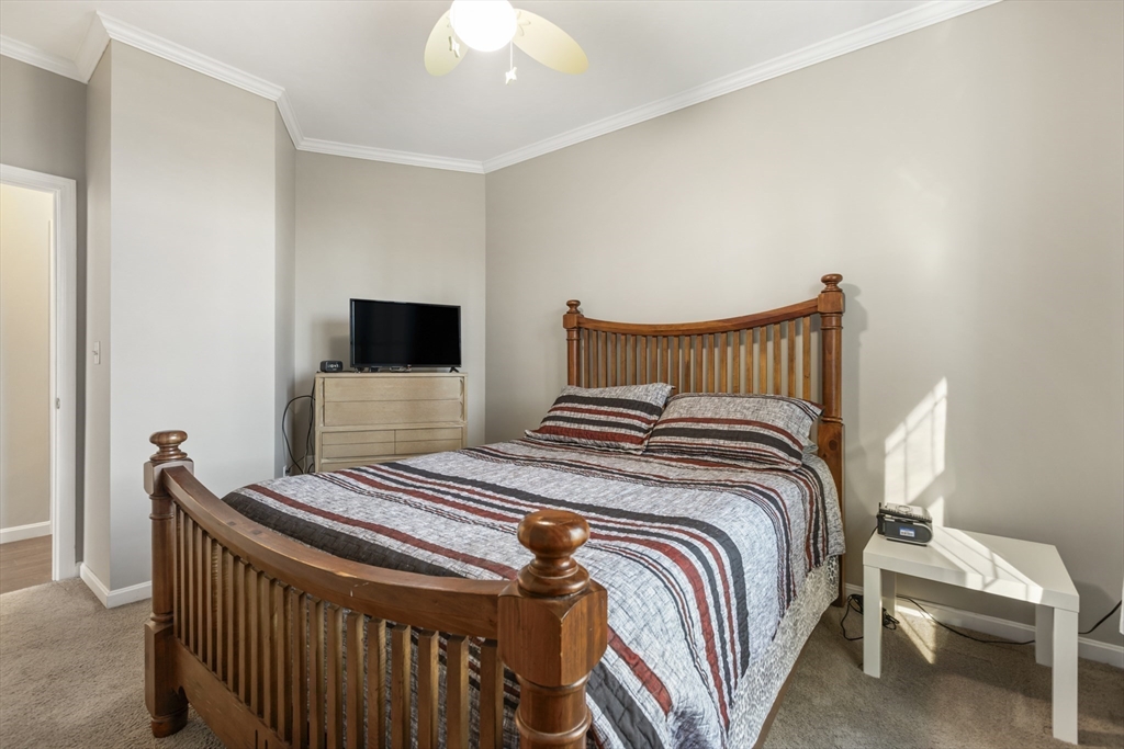 204 Brookfield Road Charlton, MA 01507 - Photo 25 of 36 a bedroom with a bed and a flat screen tv