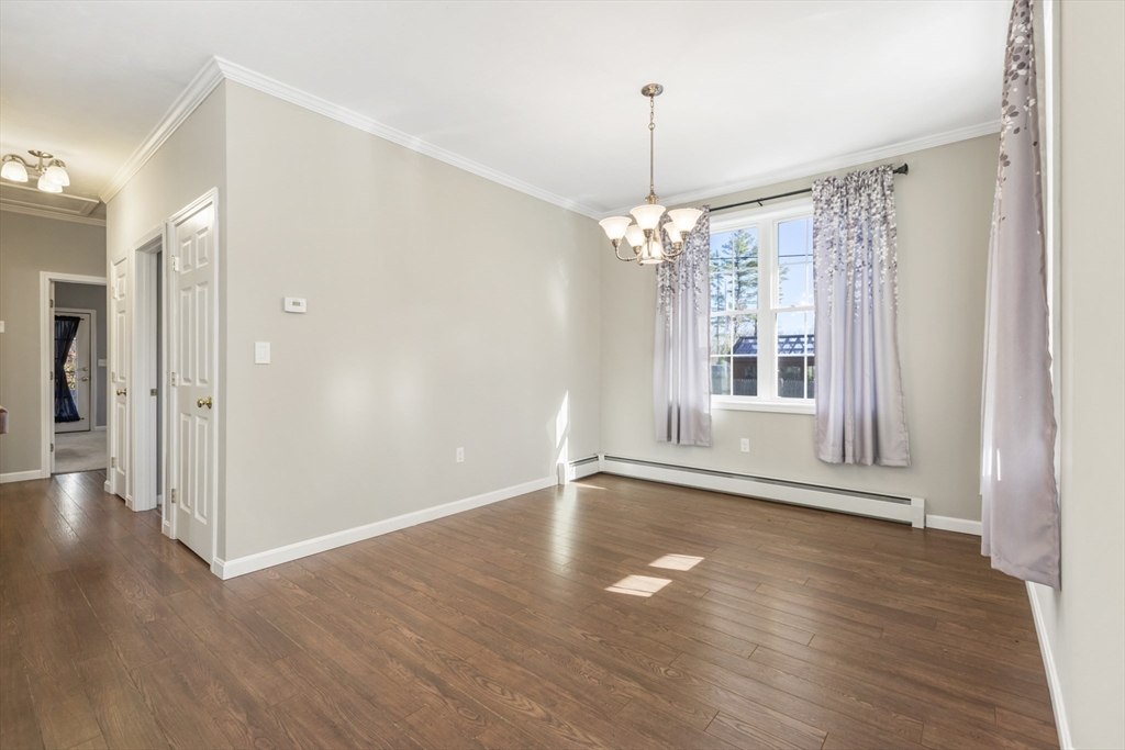 204 Brookfield Road Charlton, MA 01507 - Photo 8 of 36 a view of an empty room with wooden floor and a window
