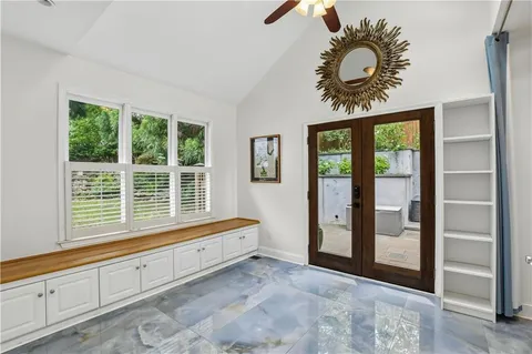 a view of a hallway with bathroom and a glass door