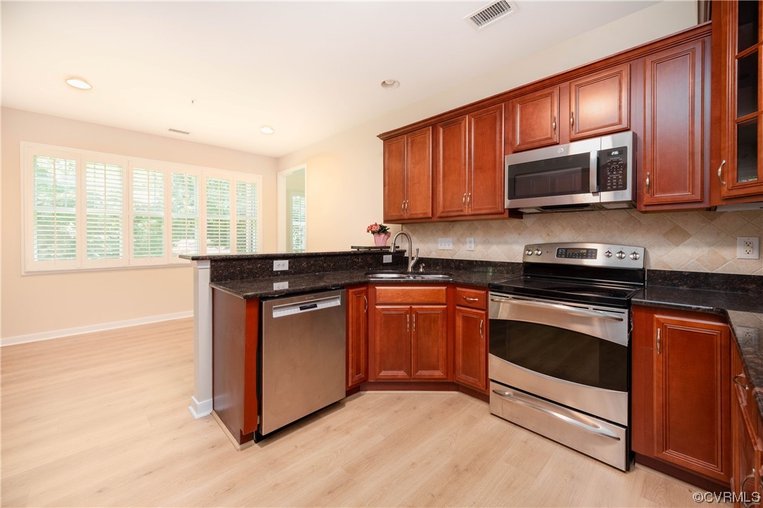 3421 Coles Point Way, Unit E Glen Allen, VA 23060 - Photo 11 of 28 a kitchen with stainless steel appliances granite countertop a stove a sink and a microwave
