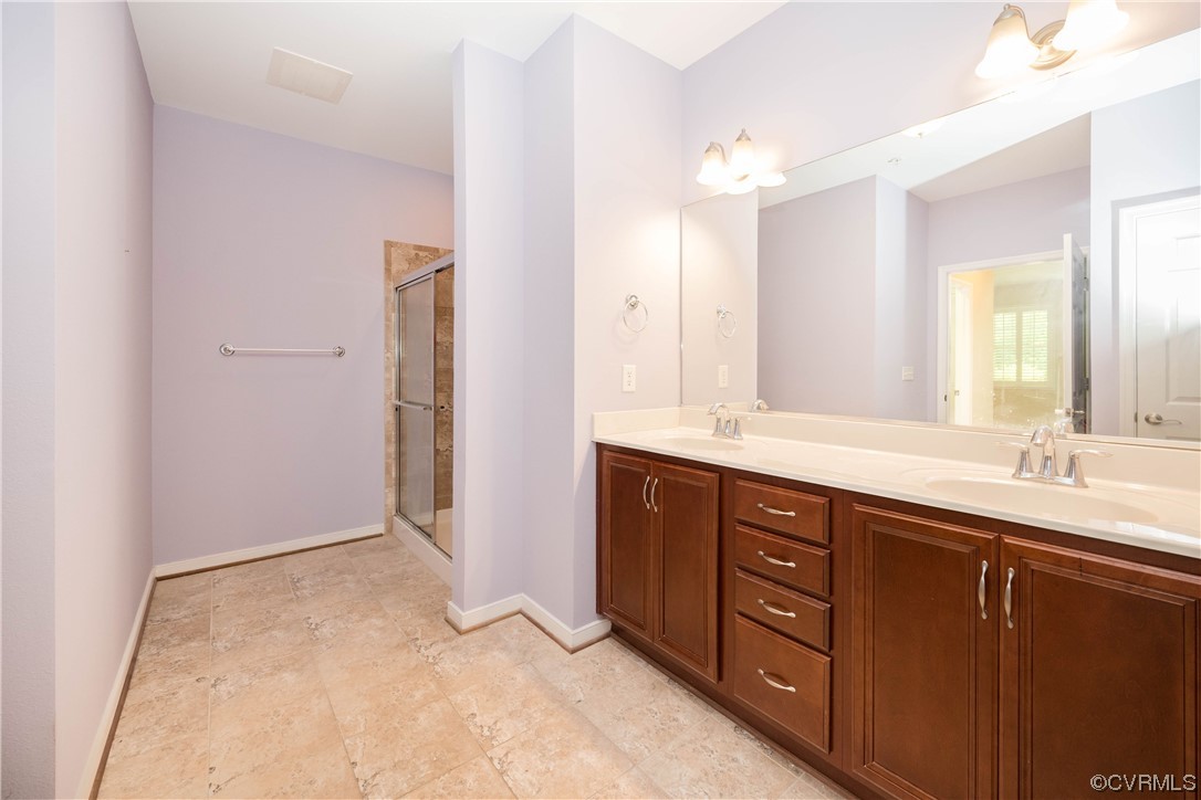 3421 Coles Point Way, Unit E Glen Allen, VA 23060 - Photo 20 of 28 a spacious bathroom with a granite countertop sink and a mirror